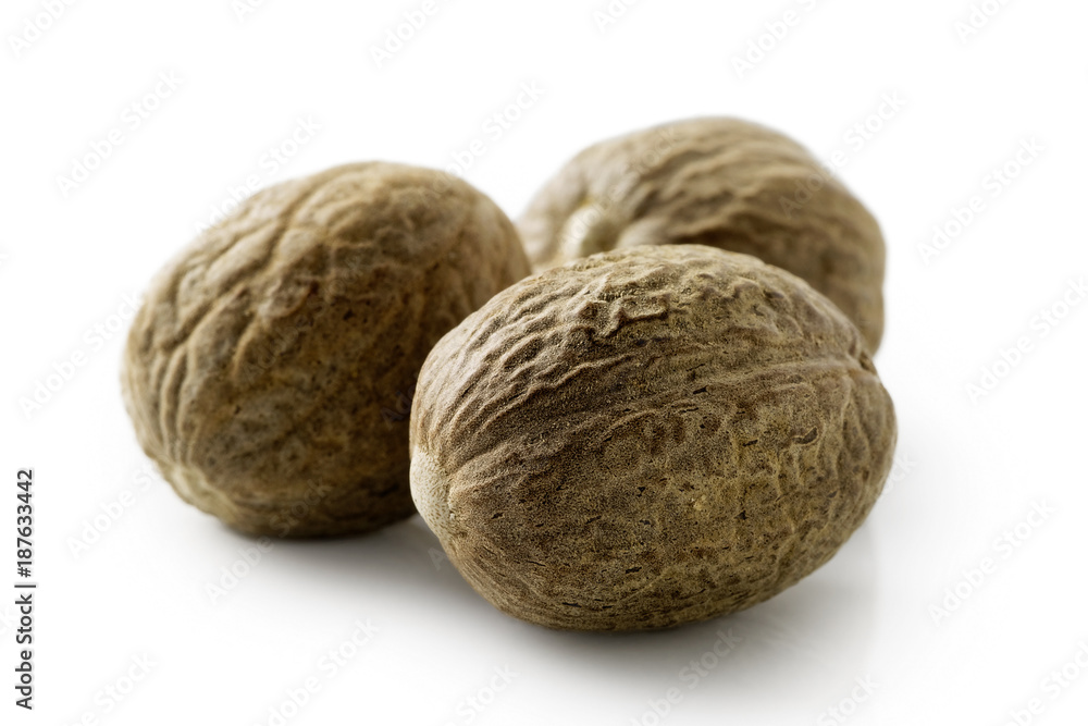 A group of dried whole nutmegs isolated on white. A group of dried whole nutmegs isolated on white.