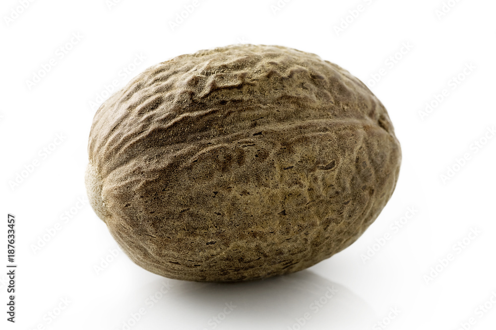 A single whole nutmeg isolated on white. A single whole nutmeg isolated on white.