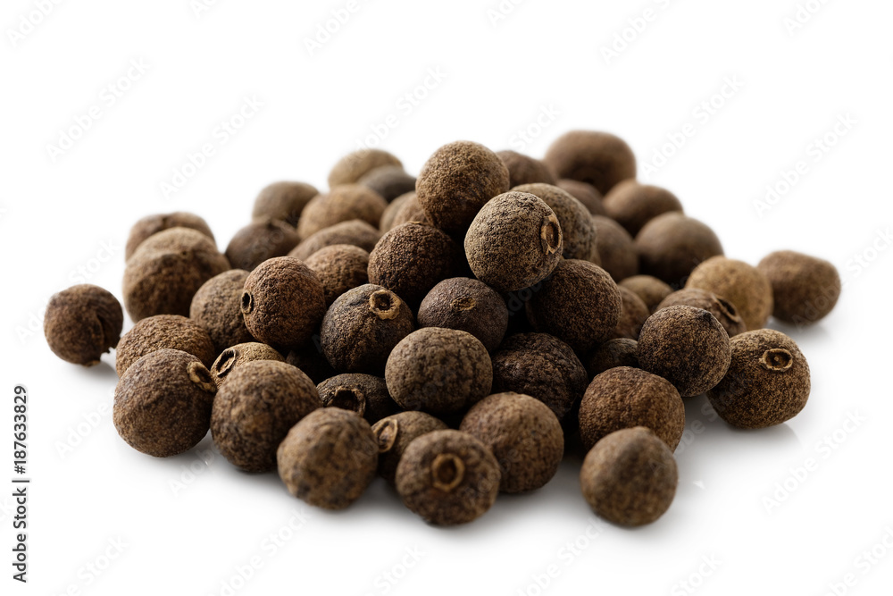 A pile of whole allspice isolated on white. - obrazy, fototapety, plakaty 