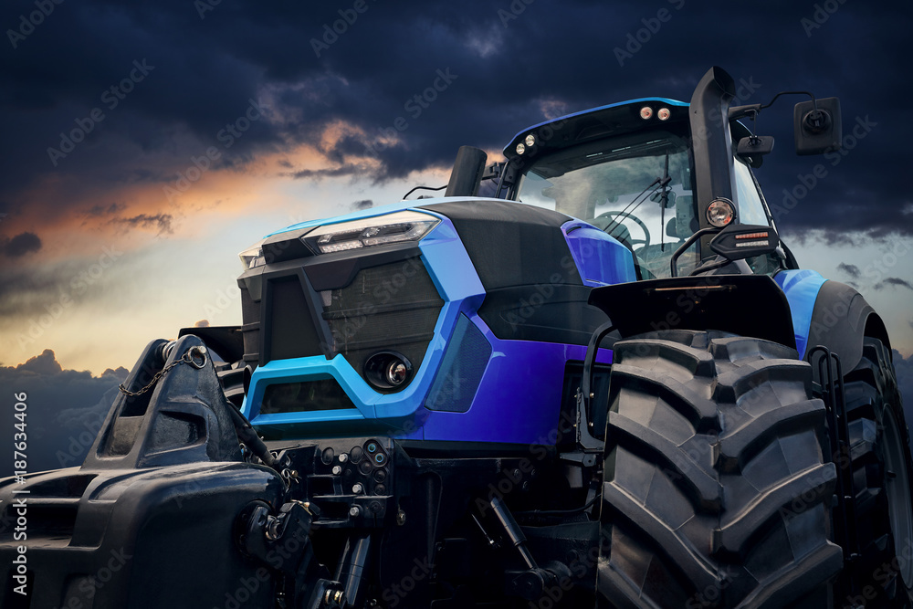 Fototapeta premium Powerful tractor against a stormy sky