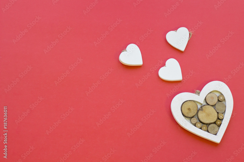 The concept of St.Valentine's Day with wooden hearts, red background top view