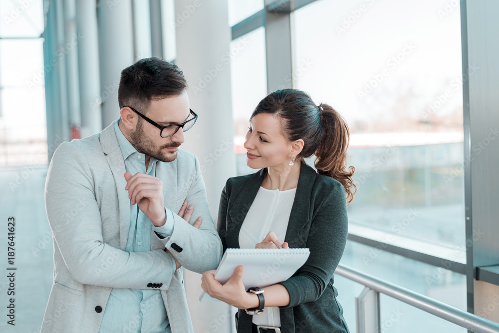 Two business people discussing about work. Two business people discussing about work.