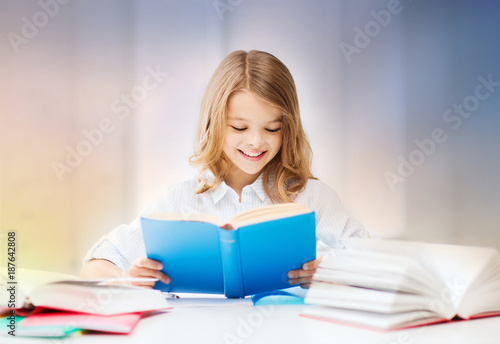 happy smiling student girl reading book