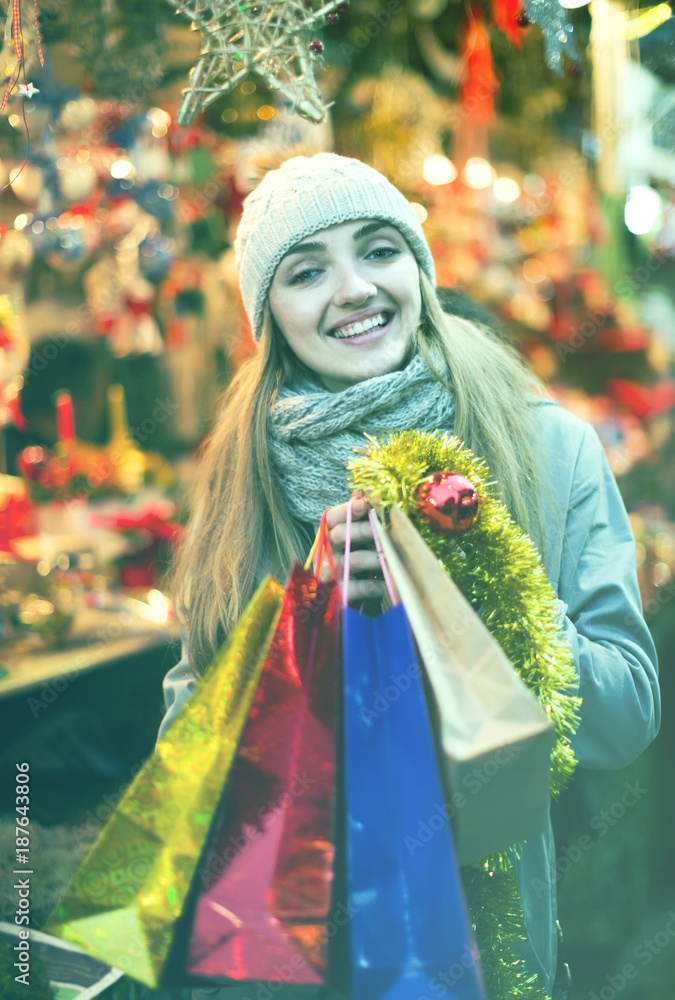 woman shopping at Christmas fair before Xmas in evening time