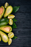 Avocado and lime on a wooden background. Top view. Free space for your text.