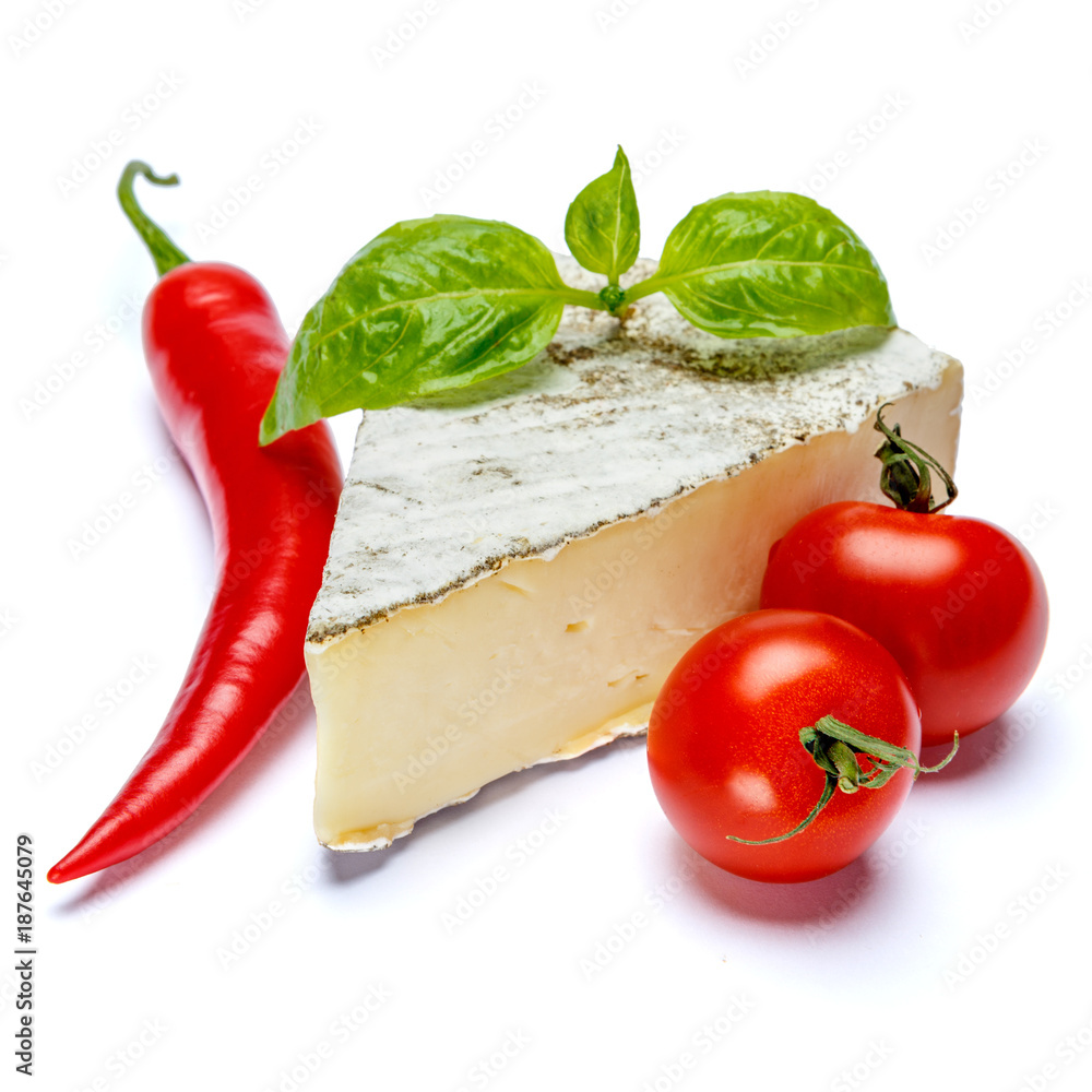 traditional french brie cheese, tomato and pepper on a white background