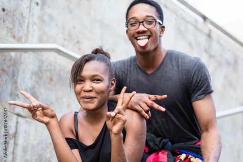 Fényképezés Portrait of young African American couple making funny faces while posing outdoo
