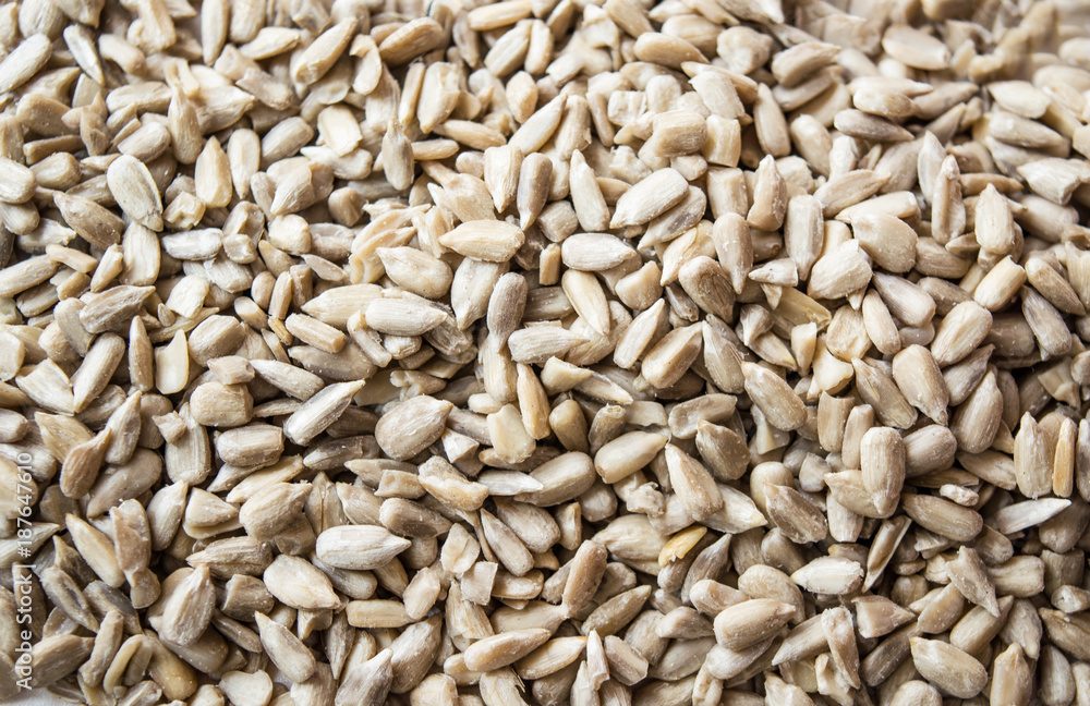Raw food. Close up of seed for sunflower on white wooden background. Raw food. Close up of seed for sunflower on white wooden background.
