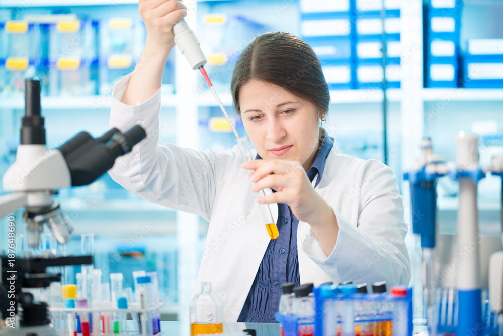 Girl laboratory assistant in the chemical laboratory of the university experiment with chemical reagents Girl laboratory assistant in the chemical laboratory of the university experiment with chemical reagents