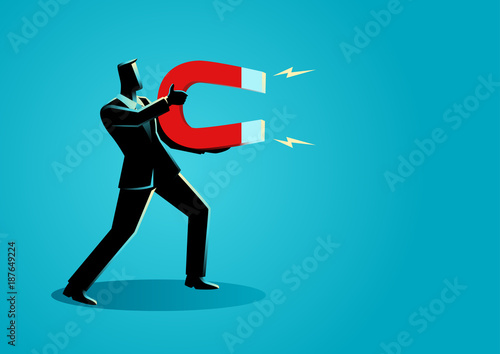 Businessman holding a large magnet