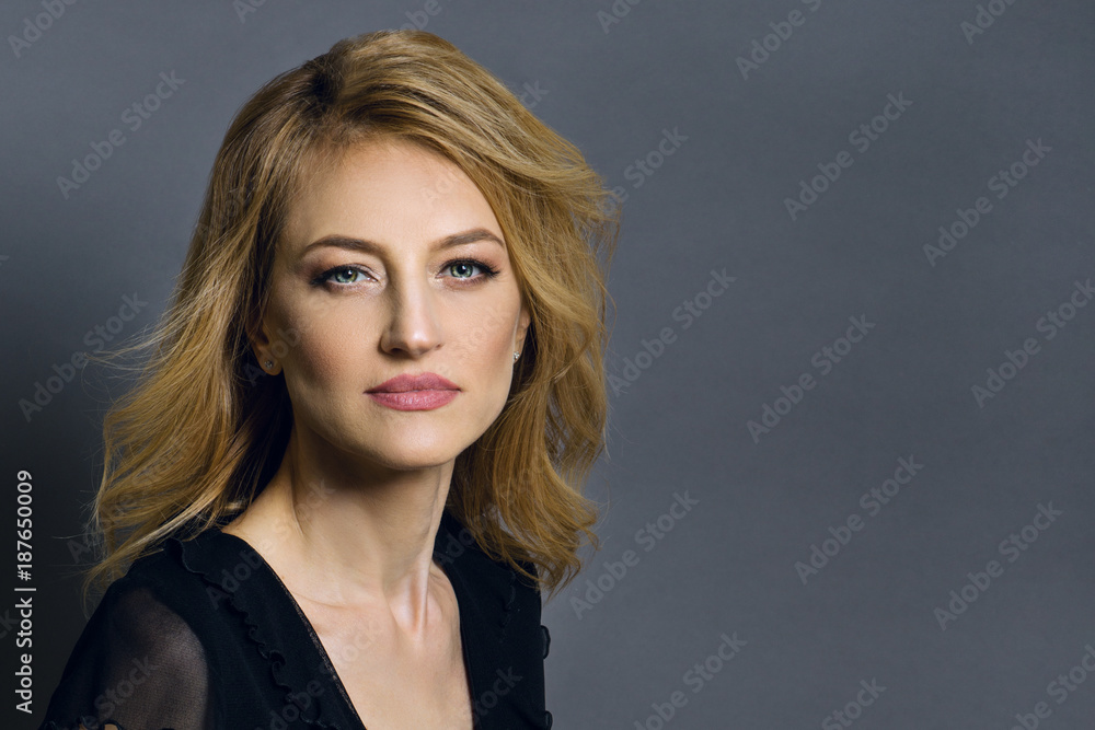 Close-up studio portrait of a beautiful middle aged blonde woman. Close-up studio portrait of a beautiful middle aged blonde woman.