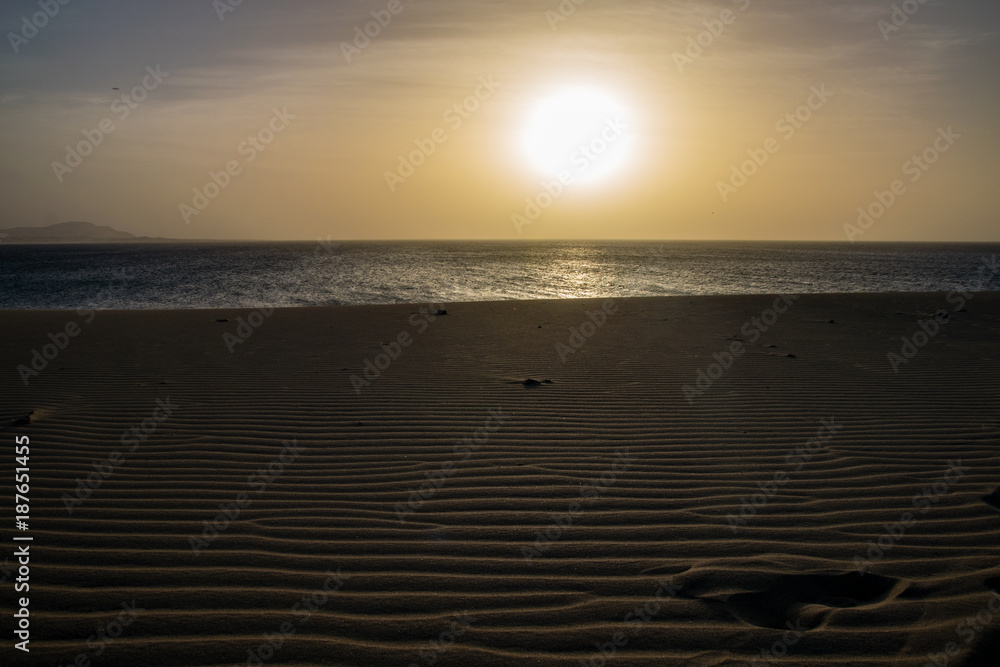 Ripples in the sand as the sun sets over the Atlantic Ocean