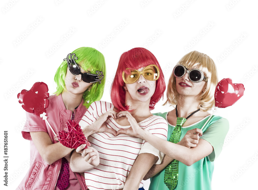Funny young girls wearing pink wigs holding love symbols and posing for the camera on a white background