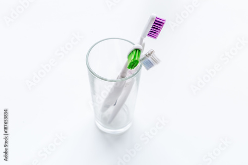 Clean teeth. Brushes in glass on white background copy space