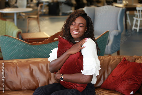 Woman embracing pillow with closed eyes