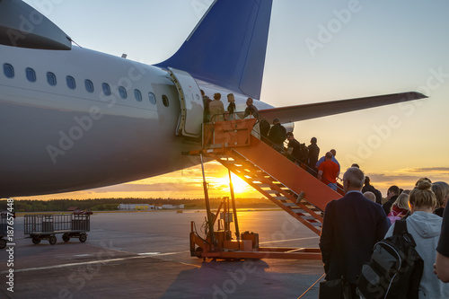 People boarding plane, travelers  photo