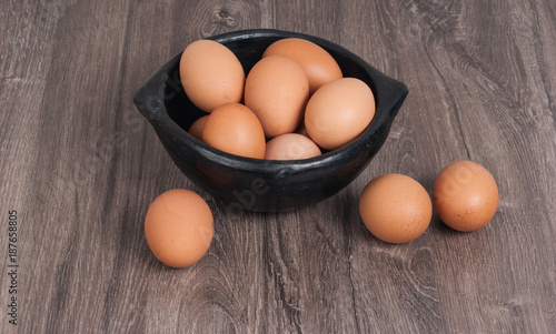 Brown eggs on wooden background