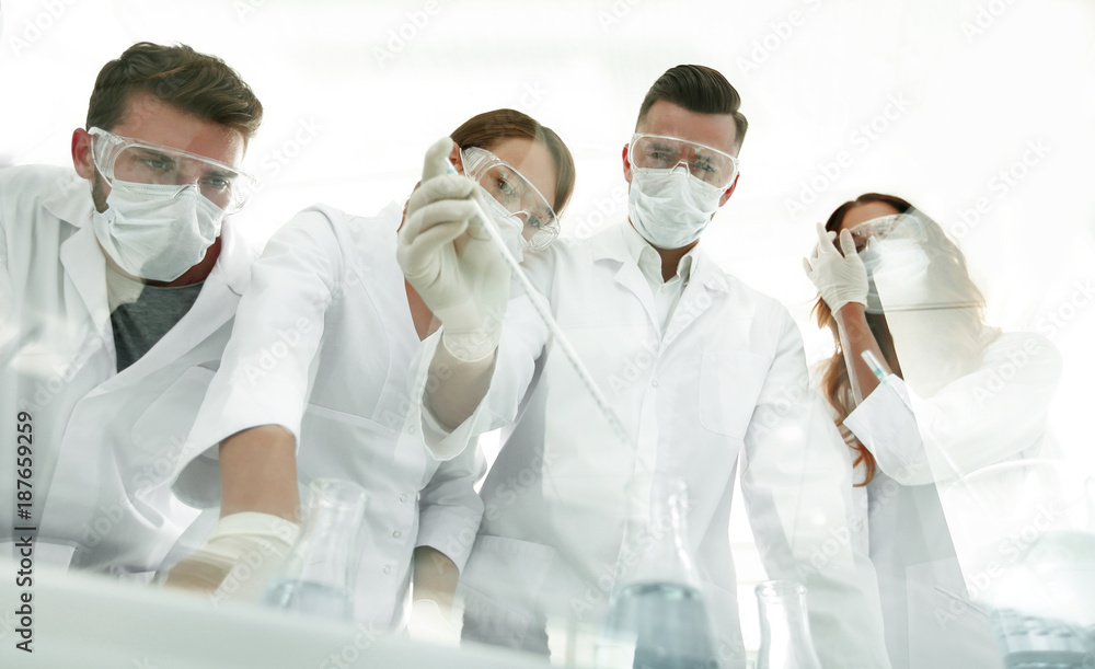 scientists working with test tubes and microscope in the laboratory scientists working with test tubes and microscope in the laboratory