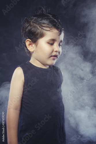 boy with hair gum in rocker dress with funny and expressive faces © Fernando Cortés