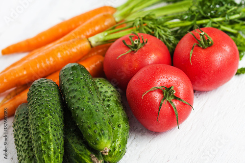 Ripe carrots, tomatoes, cucumbers in the fruit and vegetable market.