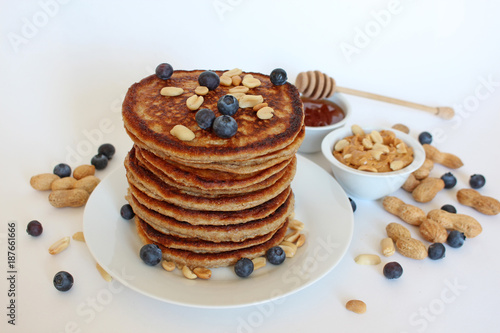 Healthy wholemeal pancakes with peanut butter and blueberries