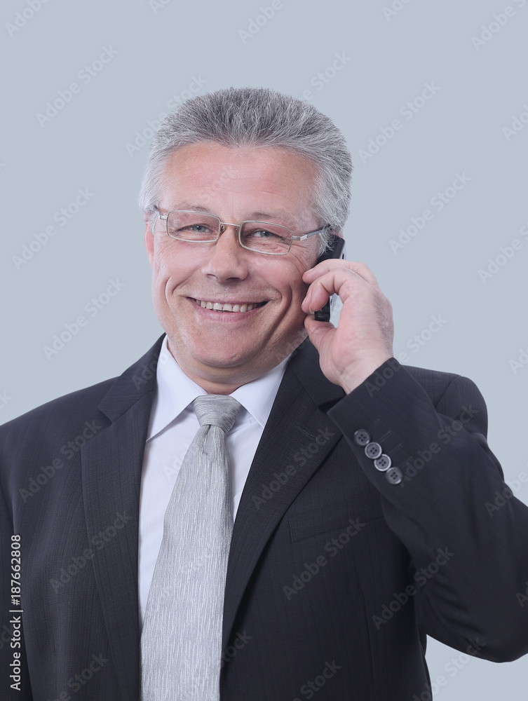 Gray-haired business man smiling isolated on gray background. Gray-haired business man smiling isolated on gray background.