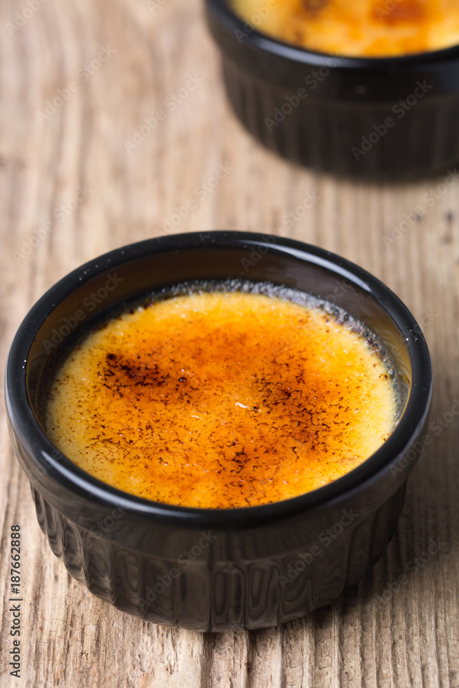 Creme brûlée in a black ramekin Creme brûlée in a black ramekin