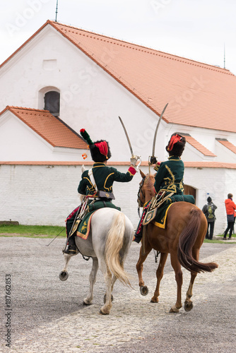 Olomouc Czech Rep. October 7th 2017 historical festival Olmutz 1813. Two napoleonic officers riding horses and fighting sabers with a church in background.