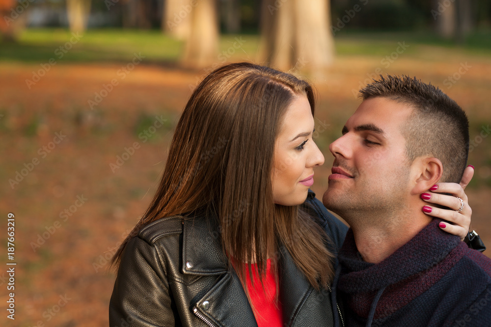 Lovely couple enjoying fall in love at park Lovely couple enjoying fall in love at park
