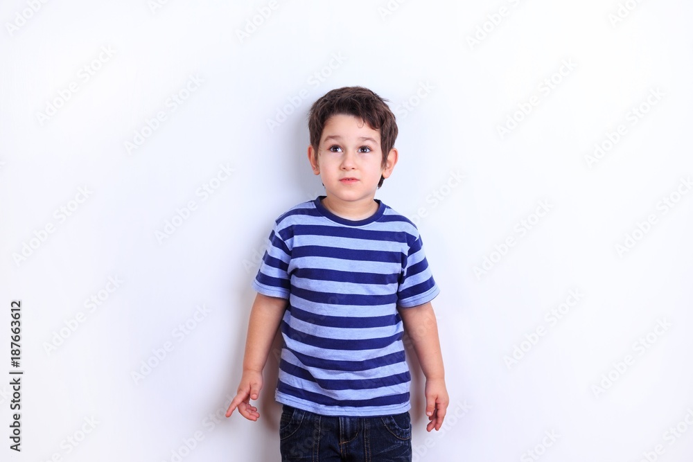Cute little shy boy close up studio shoot on white. Emotions, childhood concept Cute little shy boy close up studio shoot on white. Emotions, childhood concept