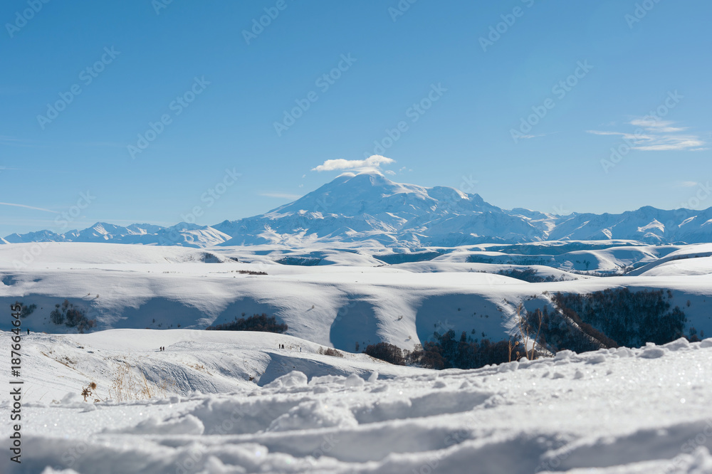 The landscape of snow-covered Caucasian rocks on the Gumbashi Pass.