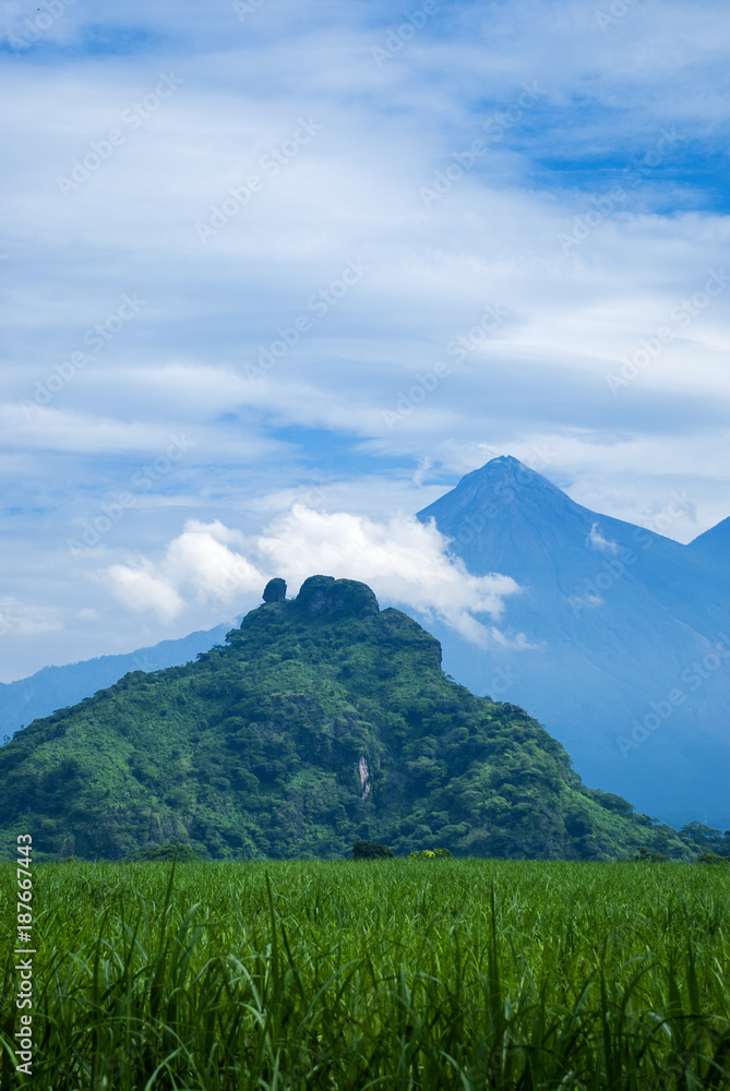 The mountains and volcano of Fuego rural scenery in summer. Guatemala, sugar cane.