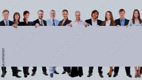 Full length of many business people in a row holding a blank banner isolated on white background.