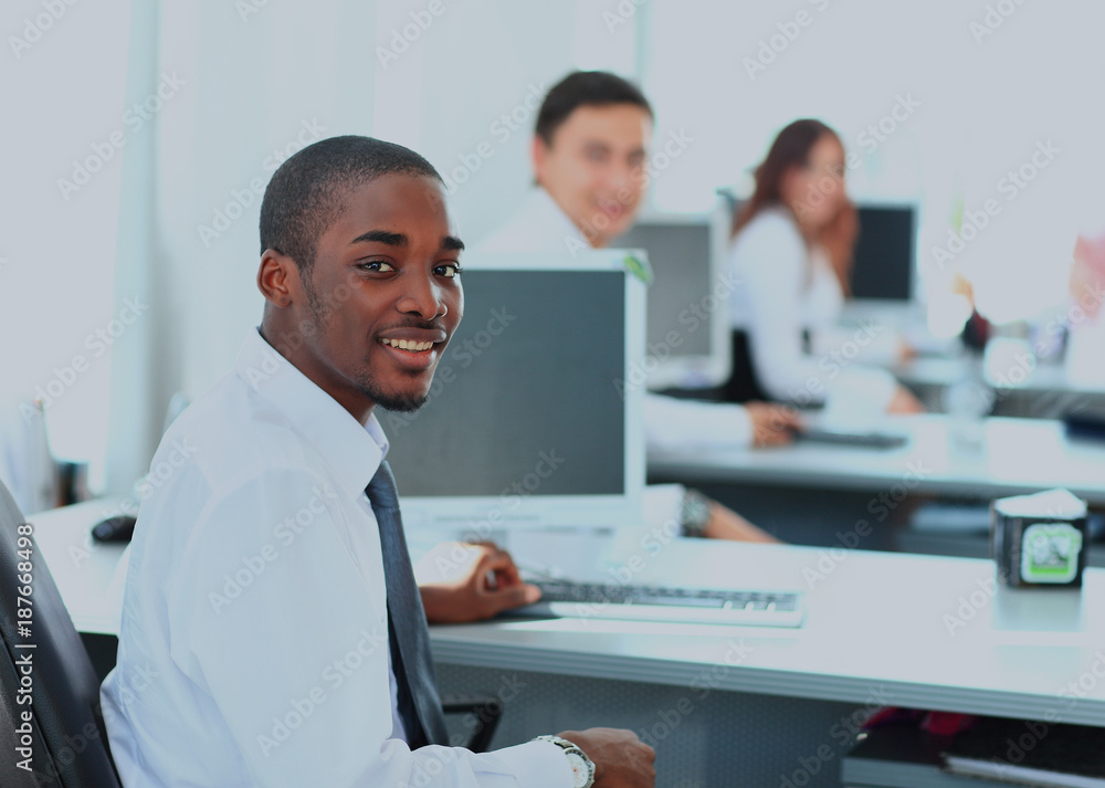 Portrait of a happy African American entrepreneur displaying computer laptop in office. Portrait of a happy African American entrepreneur displaying computer laptop in office.