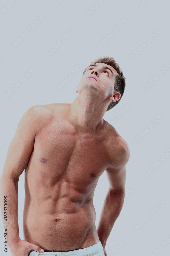 Portrait of a muscular man posing against white background Portrait of a muscular man posing against white background
