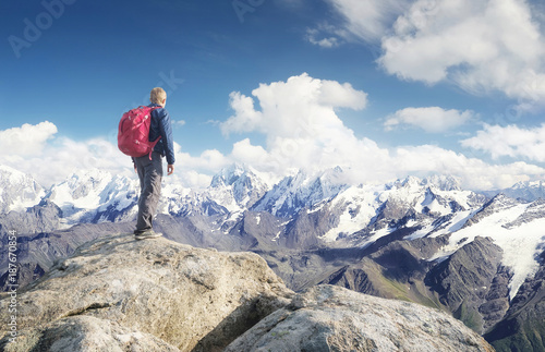 Tourist on the mountain range in the clouds. Active life concept