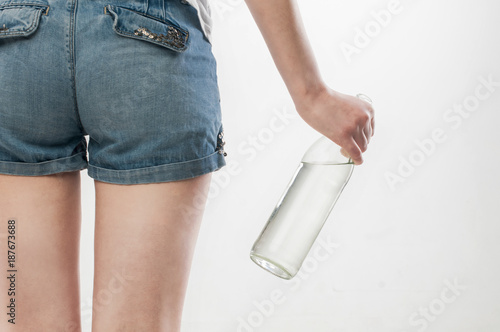 Fashion portrait of beautiful girl with bottle of champagne sings something photo