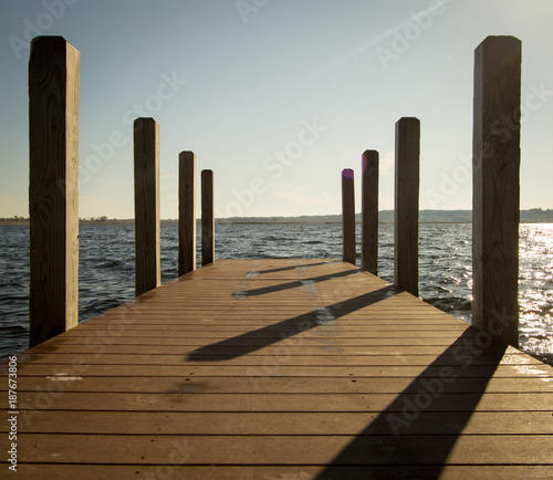 Summer Day At The Lake. Wooden dock on sunny summer day at the lake in square orientation. © ehrlif