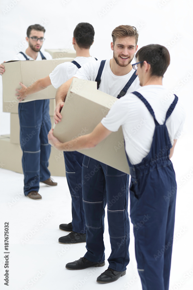 Photo workers pass each other boxes when moving flats. Photo workers pass each other boxes when moving flats.