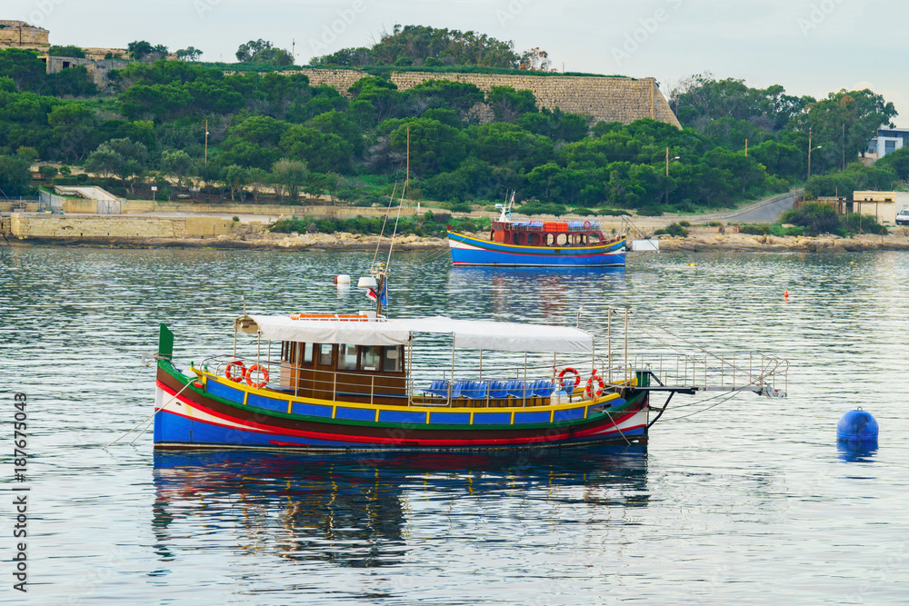 Traditional maltese boats near Manoel island. View from Sliema sity.