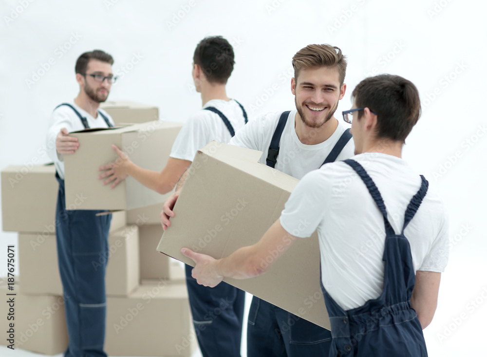 Portrait of movers holding box smiling isolated on white backgro Portrait of movers holding box smiling isolated on white backgro