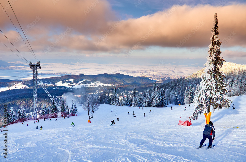 Cable car in Poiana Brasov ski resort, Skiers and snowboarders enjoy the ski  slopes in Poiana