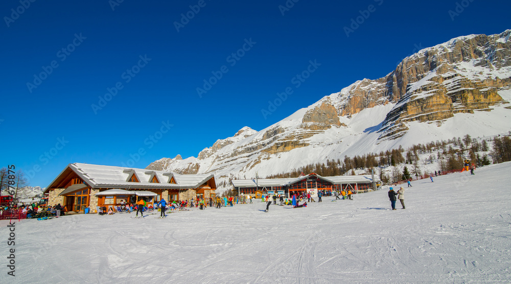 MADONNA DI CAMPIGLIO, ITALY-21 November 2014:Panoramic winter landscape of Dolomiti mountain and Mountain shelter in Madonna di Campiglio. The ski slope and skiers at Passo Groste ski area