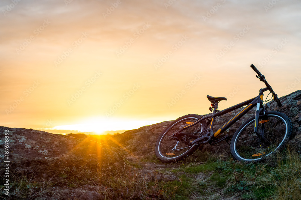 Mountain Bike on the Rocky Trail at Sunset. Extreme Sport Concept. Space for Text.