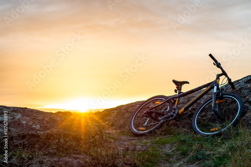 Mountain Bike on the Rocky Trail at Sunset. Extreme Sport Concept. Space for Text.