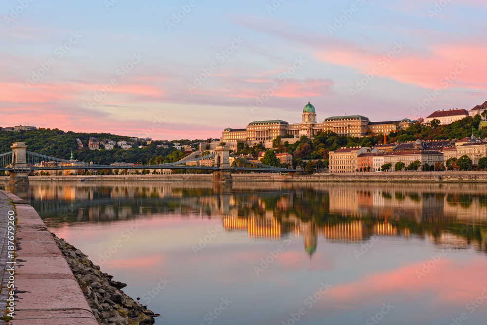 King's Palace in Budapest reflected in water, morning sky, rose clouds