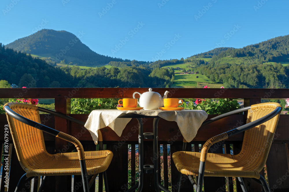 Tea served for two on sunny terrace in mountain resort