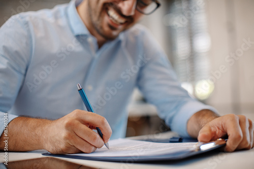 Young businessman signing a contract photo