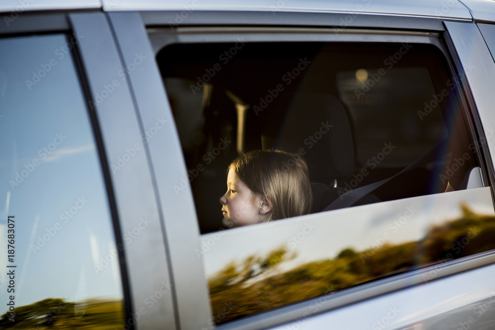 Girl sitting in car seen through window Girl sitting in car seen through window