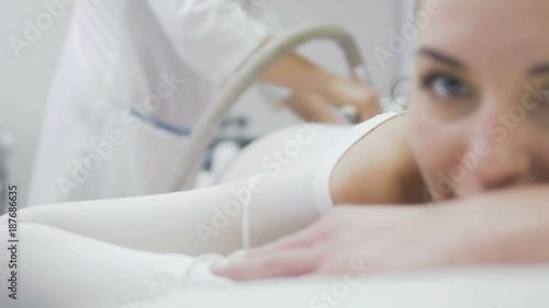 Woman enjoys massage with lpg apparatus photo